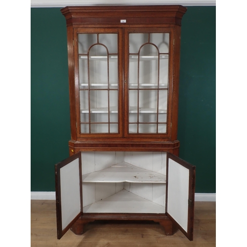 356 - A 19th Century oak and mahogany crossbanded standing Corner Cabinet fitted pair of glazed doors abov... 