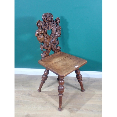 374 - An oak Hall Chair from the French Elzas region with heart pierced back flanked by mermaids dated 188... 