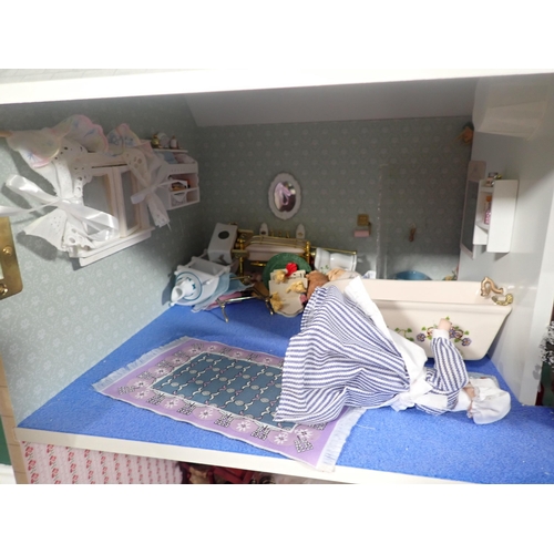 394 - A modern Doll's House with Dolls and Furniture 2ft 8in H x 2ft 4in W