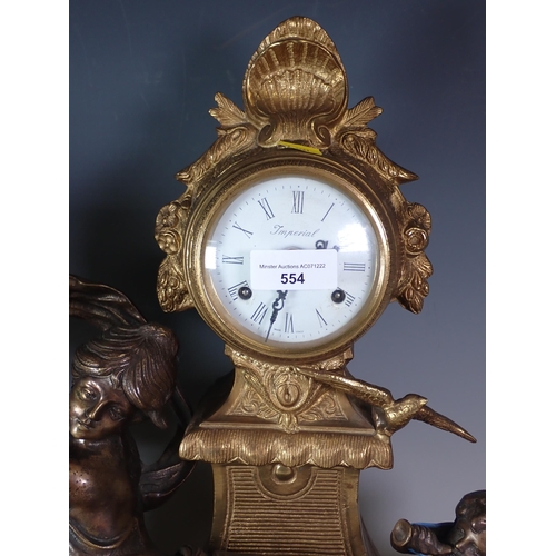 554 - A gilt metal Mantel Clock with reclining girl and cherub in the manner of Moreau, and an Oil Lamp