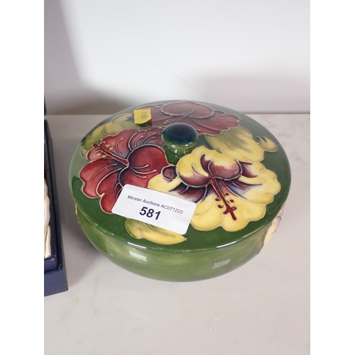 581 - A Moorcroft lidded Powder Bowl with hibiscus design on a green ground, 6in D and a box of six miniat... 