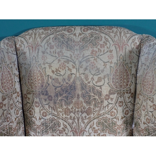 6 - An upholstered wingback Armchair on shell carved cabriole front supports and another wing Armchair o... 