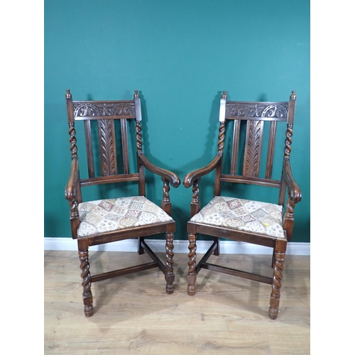 606 - A pair of oak Armchairs with lunette and leafage carved rail and floral upholstered drop in seats