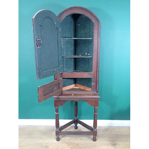 612 - An 18th Century oak Corner Cupboard on later stand with arched fielded panel door 5ft 10in H x 2ft W