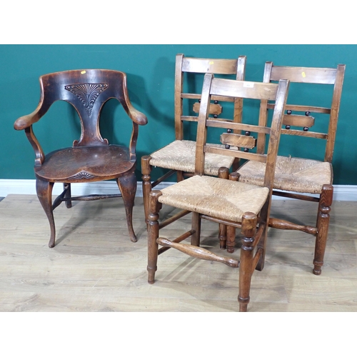 618 - An oak Elbow Chair on cabriole supports and three rush seated ash Chairs