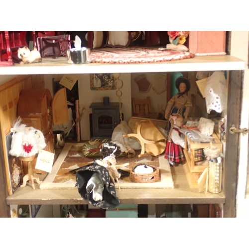 646 - A timber framed style Doll's House 'Griffindor' with Dolls and Furniture 2ft 9in H x 1ft 6in W