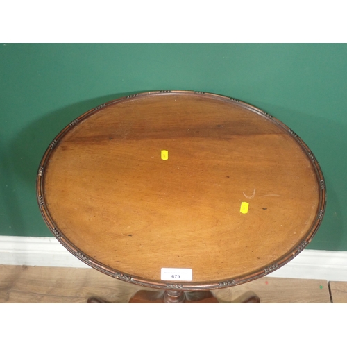 679 - A circular mahogany Wine Table with carved edge, on turned column and tripod base, A/F.