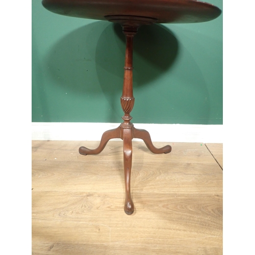 679 - A circular mahogany Wine Table with carved edge, on turned column and tripod base, A/F.