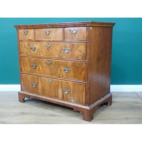 80 - An Georgian style walnut veneered Chest of three short and three long drawers mounted on bracket fee... 