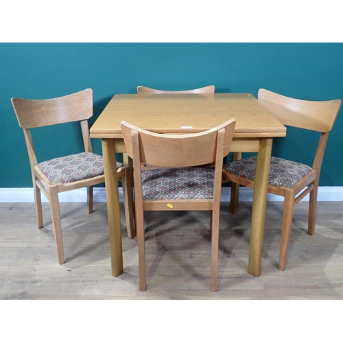 88 - A draw leaf Kitchen Table and four Chairs, the chairs stamped (EG - G Plan).