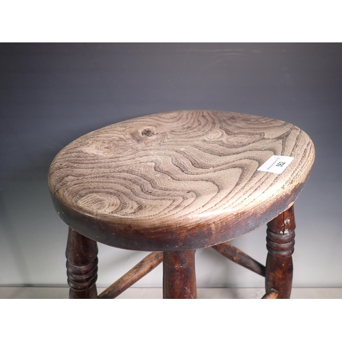 562 - An antique ash and elm Stool