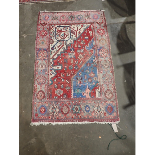 665 - A Persian Rug with bands of blue, red and cream ground decorated stylised flowers within border with... 