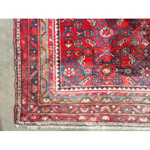 667 - Two red ground Persian Rugs with designs of stylised flowers 5ft 10in L x 3ft 10in W and 7ft 2in L x... 