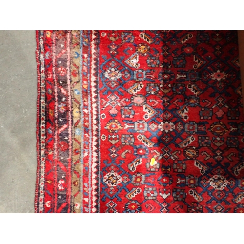 667 - Two red ground Persian Rugs with designs of stylised flowers 5ft 10in L x 3ft 10in W and 7ft 2in L x... 