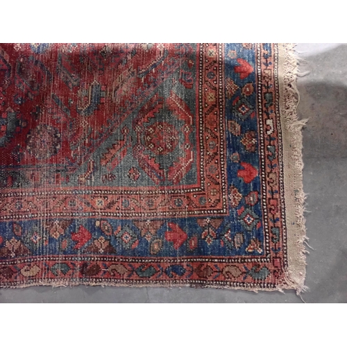 667 - Two red ground Persian Rugs with designs of stylised flowers 5ft 10in L x 3ft 10in W and 7ft 2in L x... 