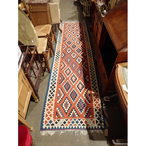 93 - A red ground Kilim Rug 4ft 6in L x 3ft W and a Kilim Runner with diamond design on red ground within... 