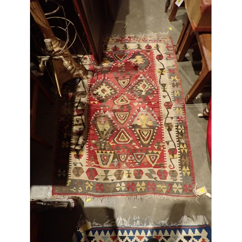 93 - A red ground Kilim Rug 4ft 6in L x 3ft W and a Kilim Runner with diamond design on red ground within... 