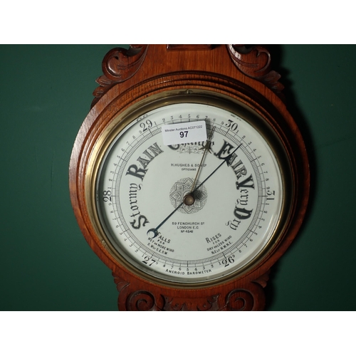 97 - An oak cased Aneroid Barometer and Thermometer with white enamel circular dial, inscribed H. Hughes ... 