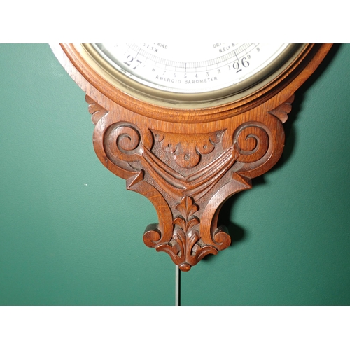 97 - An oak cased Aneroid Barometer and Thermometer with white enamel circular dial, inscribed H. Hughes ... 