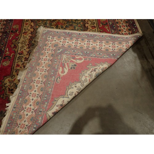 396 - A woollen red ground Persian Carpet with blue central lozenge and stylised floral design 11ft 10in L... 