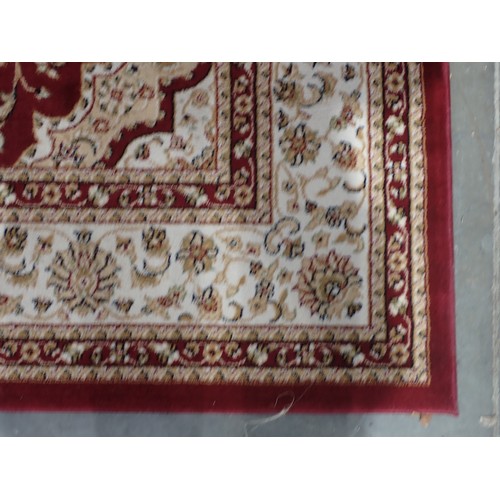 397 - A Dunelm Rug with floral design on a red ground, 7ft 6in x 5ft 3in