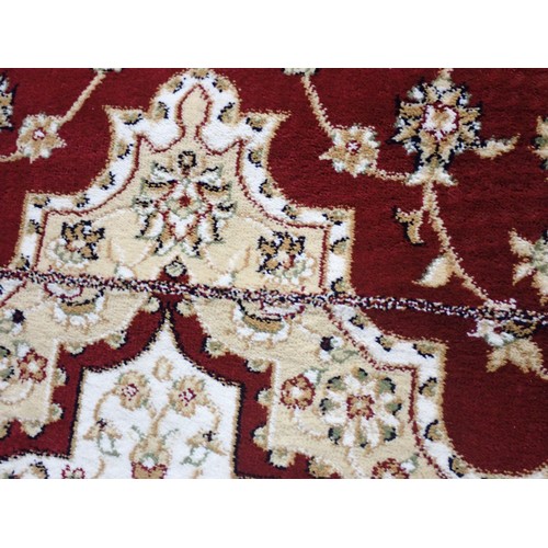 397 - A Dunelm Rug with floral design on a red ground, 7ft 6in x 5ft 3in