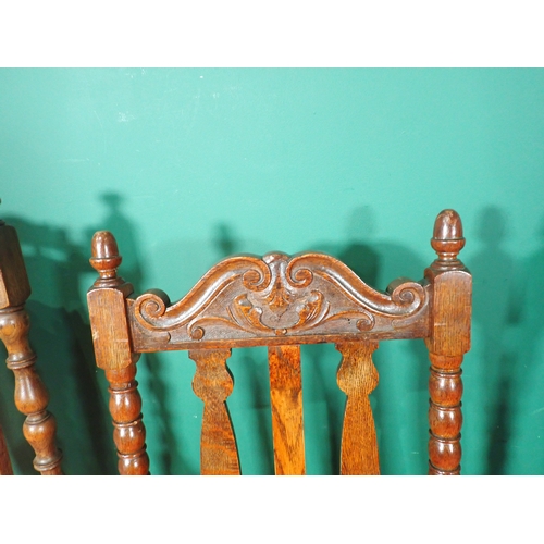 20 - A matched set of five oak Dining Chairs with carved top rails and red upholstered seats