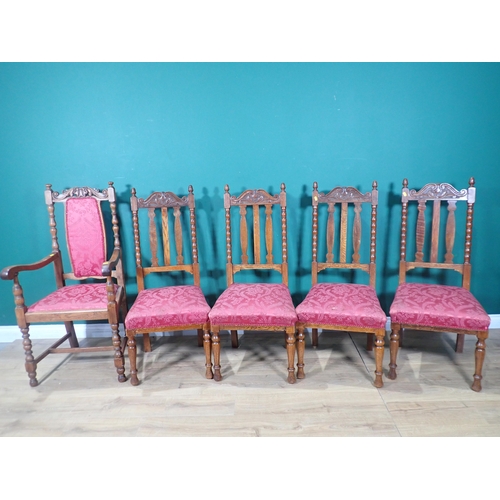 335 - A matched set of five oak Dining Chairs with carved top rails and red upholstered seats