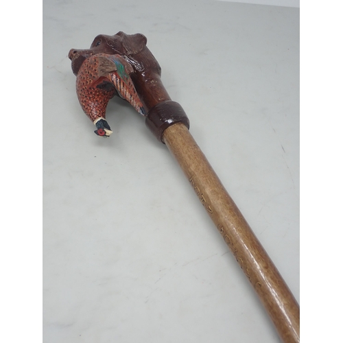 19 - A hazel Walking Stick with carved and painted Labrador and cock Pheasant handle signed John Goudy 4f... 