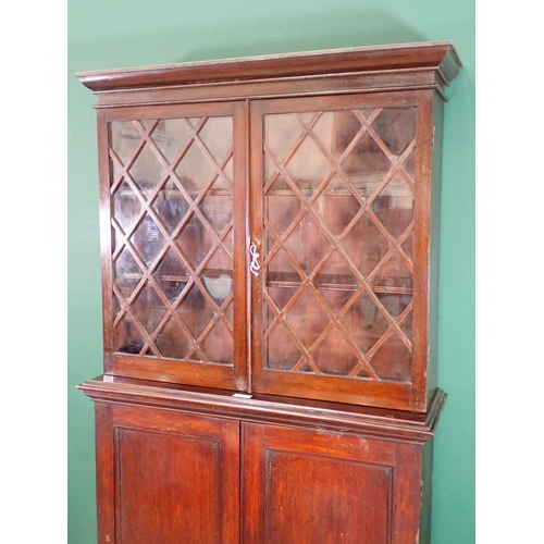 31 - An antique mahogany Bookcase with lattice glazed upper section above base fitted two cupboard doors ... 