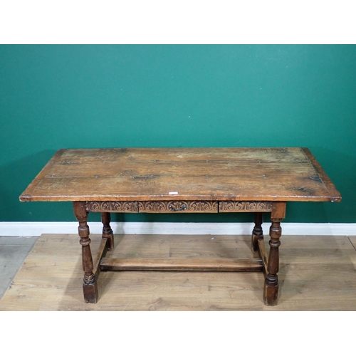 313 - An oak Refectory Table in the 17th Century style with cleated three plank lid and leafage carved fri... 