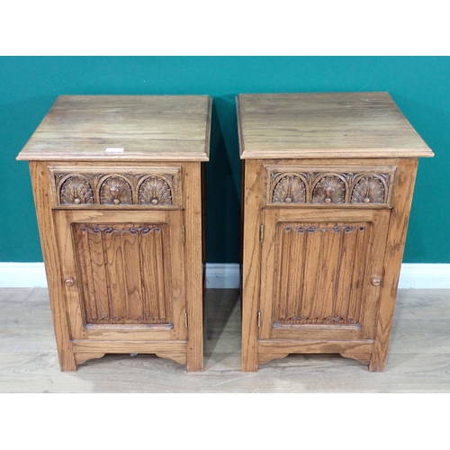 316 - A pair of oak Bedside Cupboards with leafage carved drawers and linenfold doors 2ft 6in H x 1ft 8in ... 