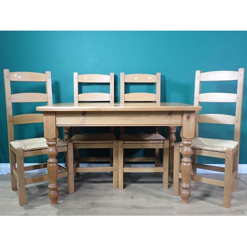 338 - A modern pine Kitchen Table on turned supports 4ft W x 2ft 6in H and four rush seated Kitchen Chairs