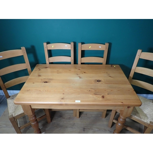 338 - A modern pine Kitchen Table on turned supports 4ft W x 2ft 6in H and four rush seated Kitchen Chairs