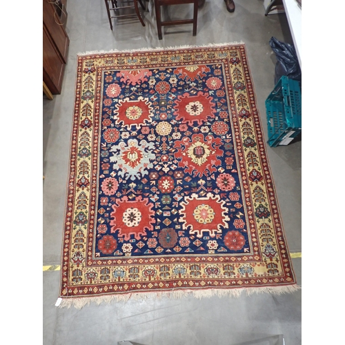 378 - A Persian type Rug with stylised flowers on blue ground within red and cream tramline border 9ft 3in... 