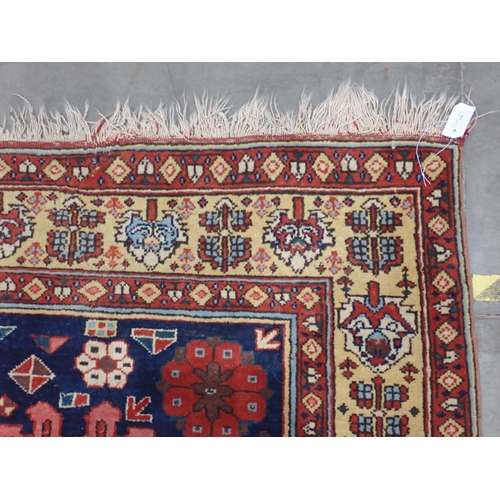 378 - A Persian type Rug with stylised flowers on blue ground within red and cream tramline border 9ft 3in... 