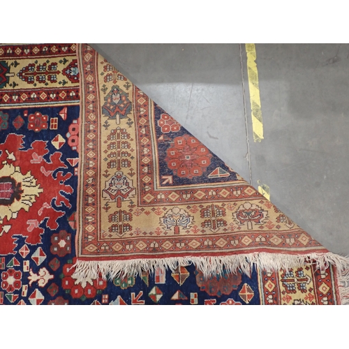 378 - A Persian type Rug with stylised flowers on blue ground within red and cream tramline border 9ft 3in... 