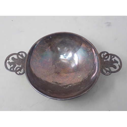 4 - An Arts and Craft white metal Quaich with pierced handles with squirrels 9in D and a hammered silver... 