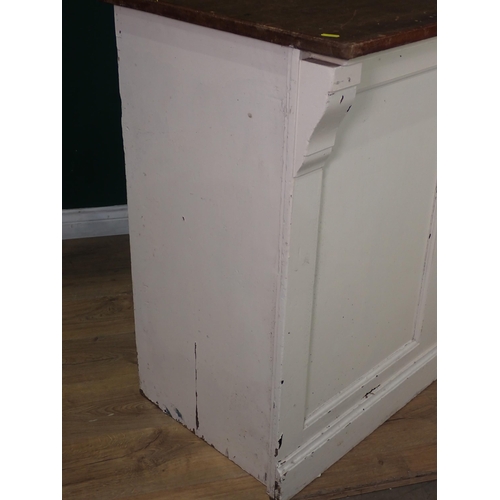 505 - An antique white painted Shop Counter with mahogany top, panelled front, fitted with four drawers an... 