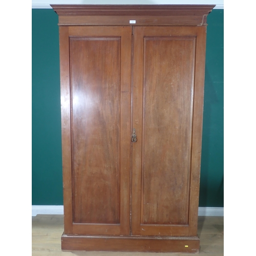 522 - A walnut two door Wardrobe, label for 