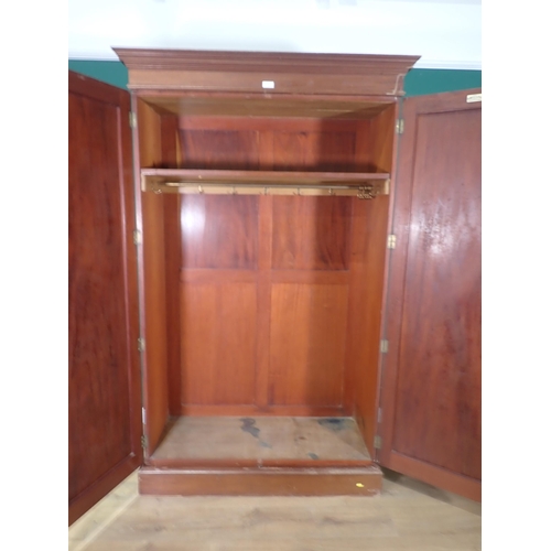 522 - A walnut two door Wardrobe, label for 