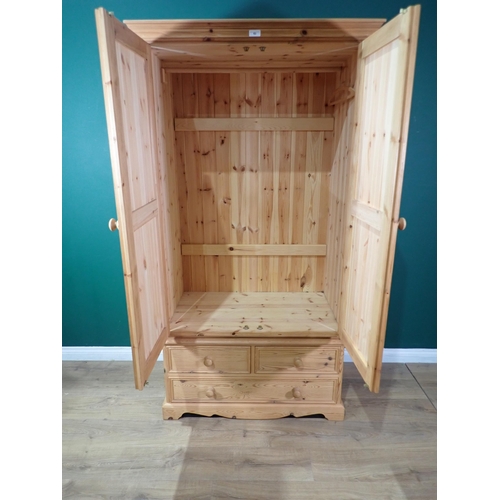 63 - A modern pine two door Wardrobe fitted two short and one long drawer to base 6ft 4in H x 3ft 5in W