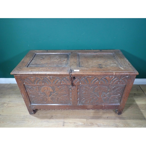 70 - A 17th Century oak Coffer with sunken two panel lid above leafage carved two panel front mounted on ... 