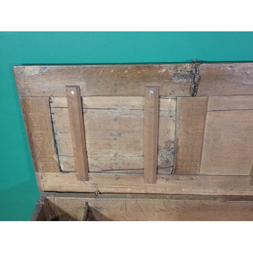 70 - A 17th Century oak Coffer with sunken two panel lid above leafage carved two panel front mounted on ... 