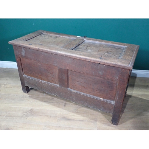 70 - A 17th Century oak Coffer with sunken two panel lid above leafage carved two panel front mounted on ... 