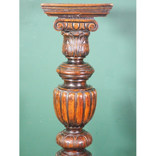 87 - An antique oak Torchere with leafage carved and gadrooned turned column on square base 4ft 7in H x 1... 