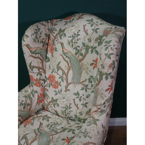 91 - A wingback Armchair with bird of paradise design cover mounted upon shell carved cabriole front supp... 