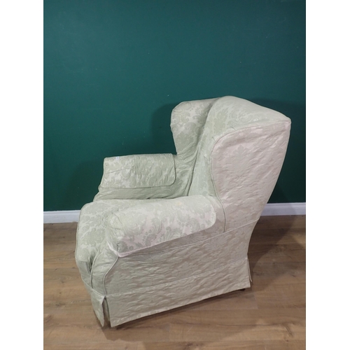 92 - A 19th Century wingback Armchair with loose cover mounted on turned supports 3ft 2in H x 3ft 2in W