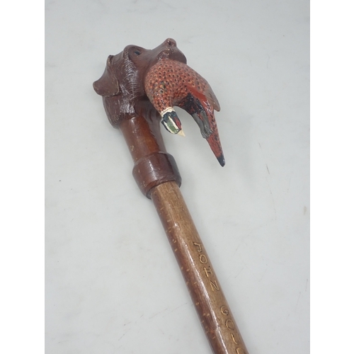 19 - A hazel Walking Stick with carved and painted Labrador and cock Pheasant handle signed John Goudy 4f... 