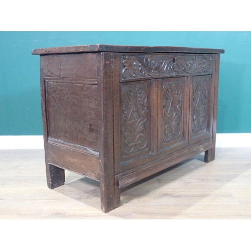 286 - A 17th Century oak Coffer with three panel sunken lid above leafage carved frieze and three carved p... 